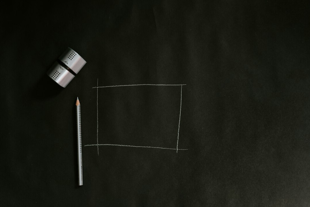Whiteboard with a hand-drawn diagram and sticky notes in a meeting room