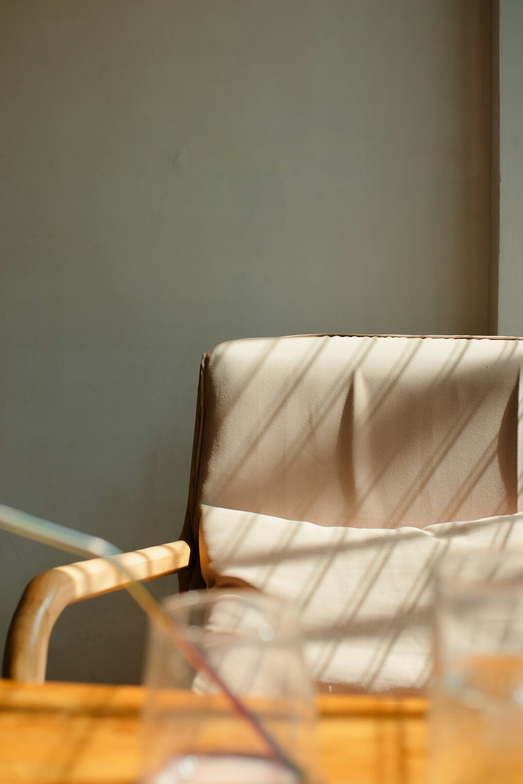 Stack of documents with a pair of glasses on a glass meeting table